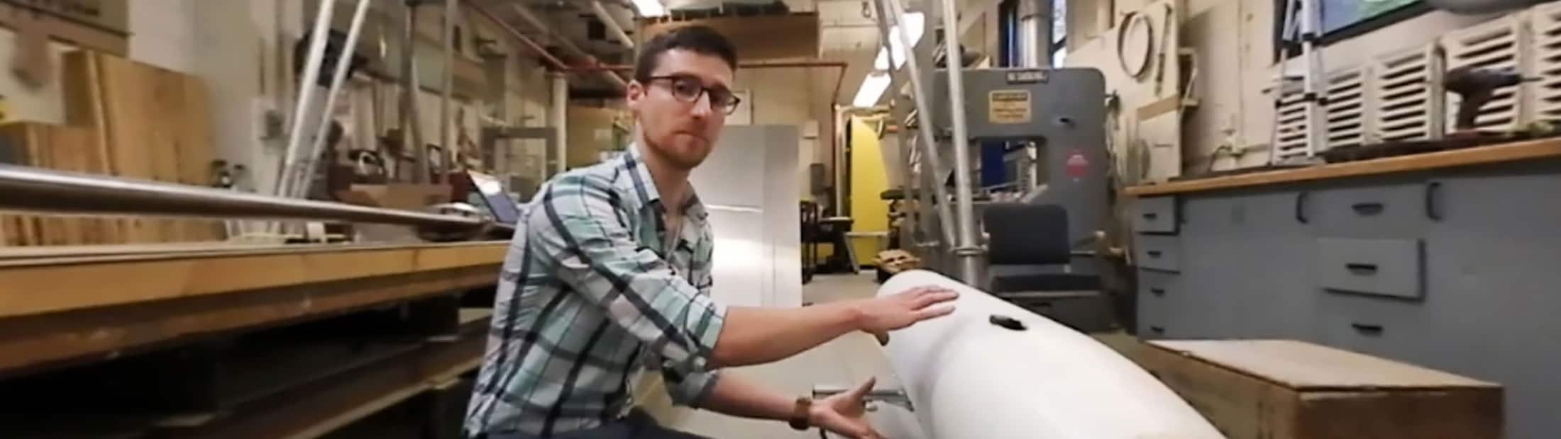 Image of James Gose working on a submarine model with an ultra water-repellent coating