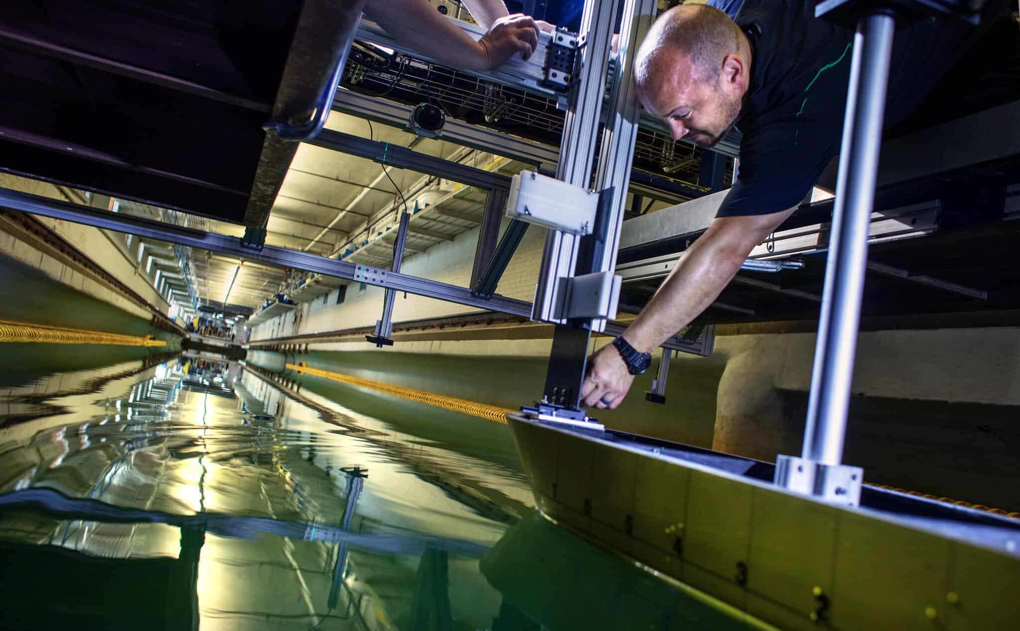 Marine Hydro Lab staff prepare and test  ship model in the Tow Tank